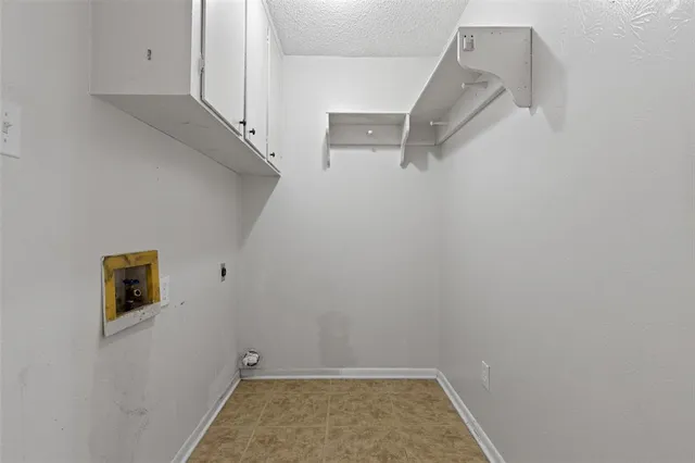 a kitchen with a refrigerator sink and cabinets
