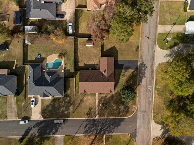 an aerial view of a houses with yard