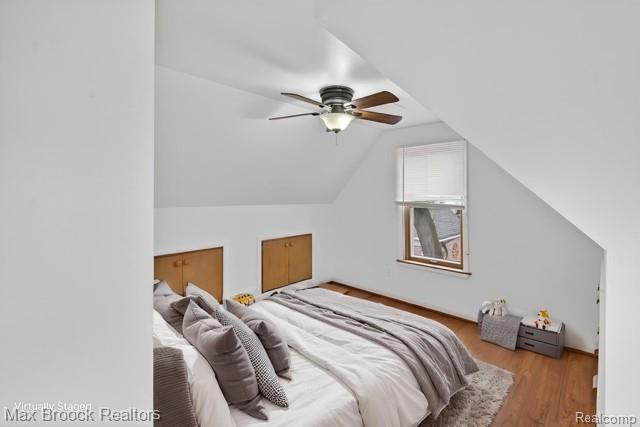 9024 Mandon Road White Lake, MI 48386 - Photo 22 of 39 Bedroom featuring wood finished floors, lofted ceiling, and a ceiling fan