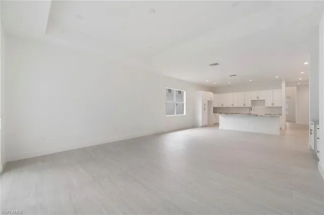 a view of a kitchen with white cabinets and a sink