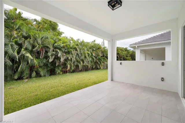 an empty room with floor to ceiling windows and an outdoor view