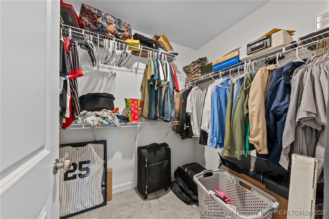 522 Carolina Church Road St. Pauls, NC 28384 - Photo 20 of 36 a view of walk in closet with clothes and shoes