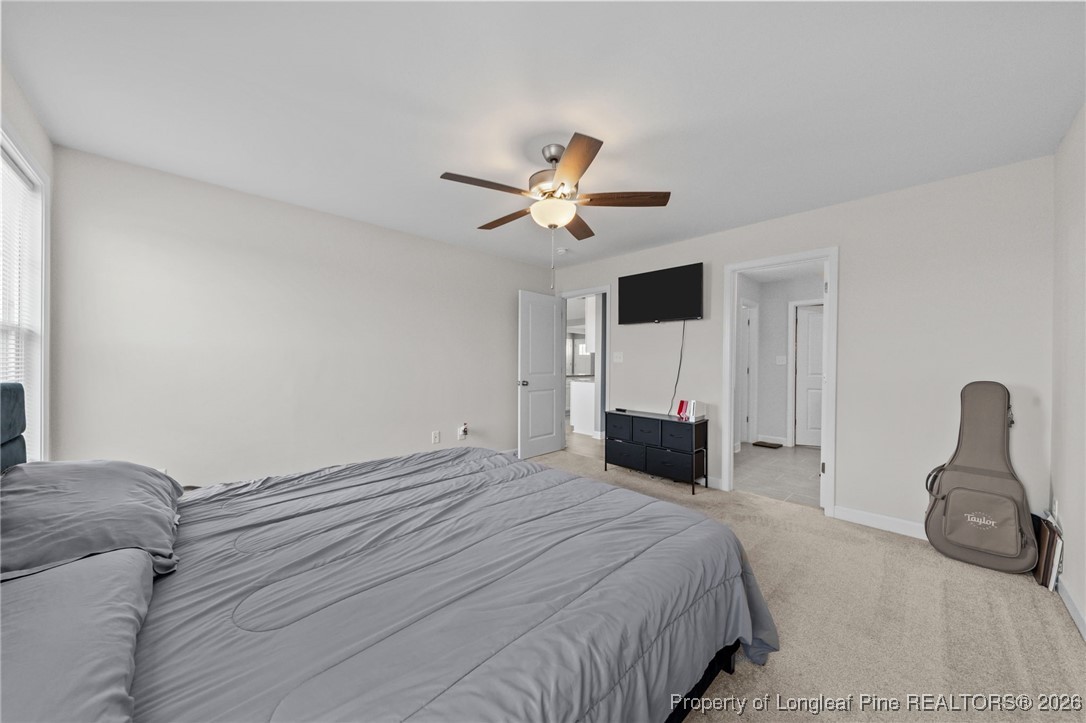 522 Carolina Church Road St. Pauls, NC 28384 - Photo 21 of 36 a bedroom with a bed and a chandelier