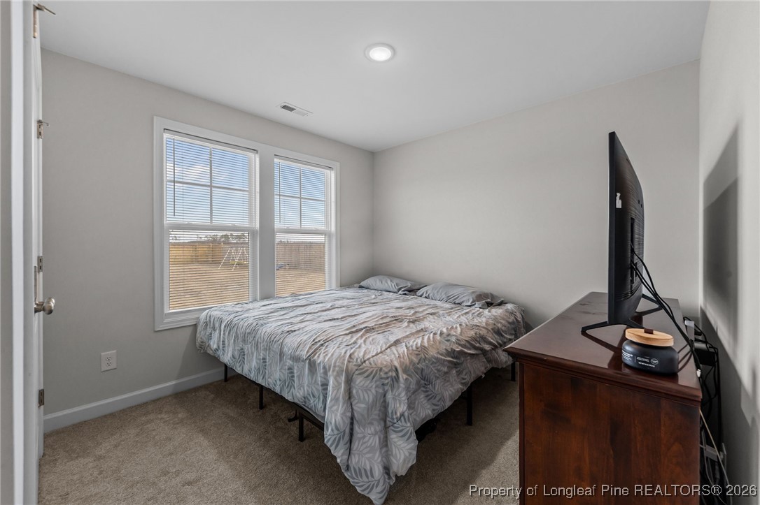 522 Carolina Church Road St. Pauls, NC 28384 - Photo 23 of 36 a bed sitting in a room next to a window