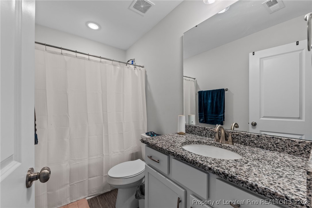 522 Carolina Church Road St. Pauls, NC 28384 - Photo 24 of 36 a bathroom with a granite countertop sink toilet and shower