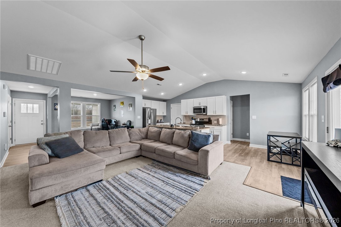 522 Carolina Church Road St. Pauls, NC 28384 - Photo 8 of 36 a living room with furniture and a chandelier