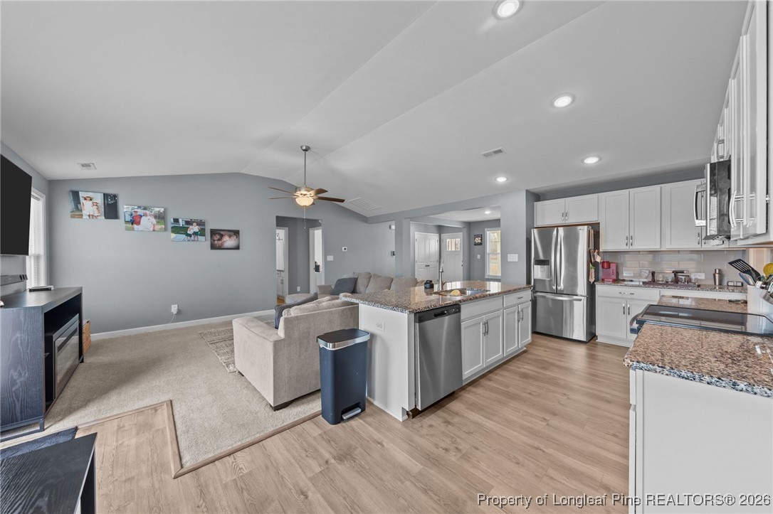 522 Carolina Church Road St. Pauls, NC 28384 - Photo 10 of 36 a large kitchen with stainless steel appliances granite countertop a lot of counter space and wooden floors