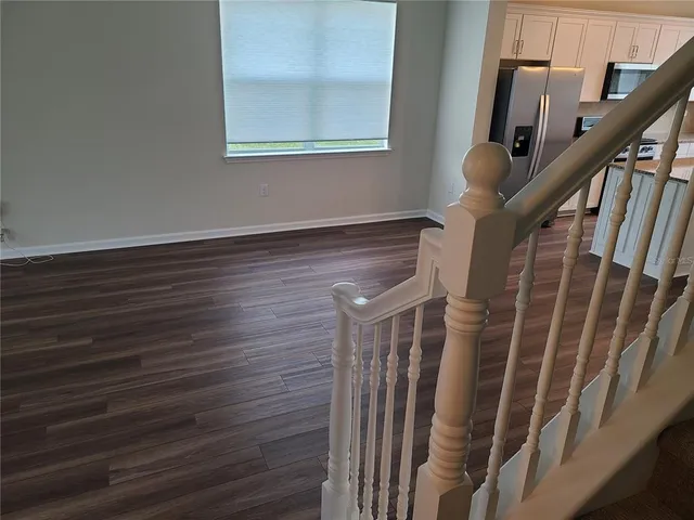a view of staircase with wooden floor and windows