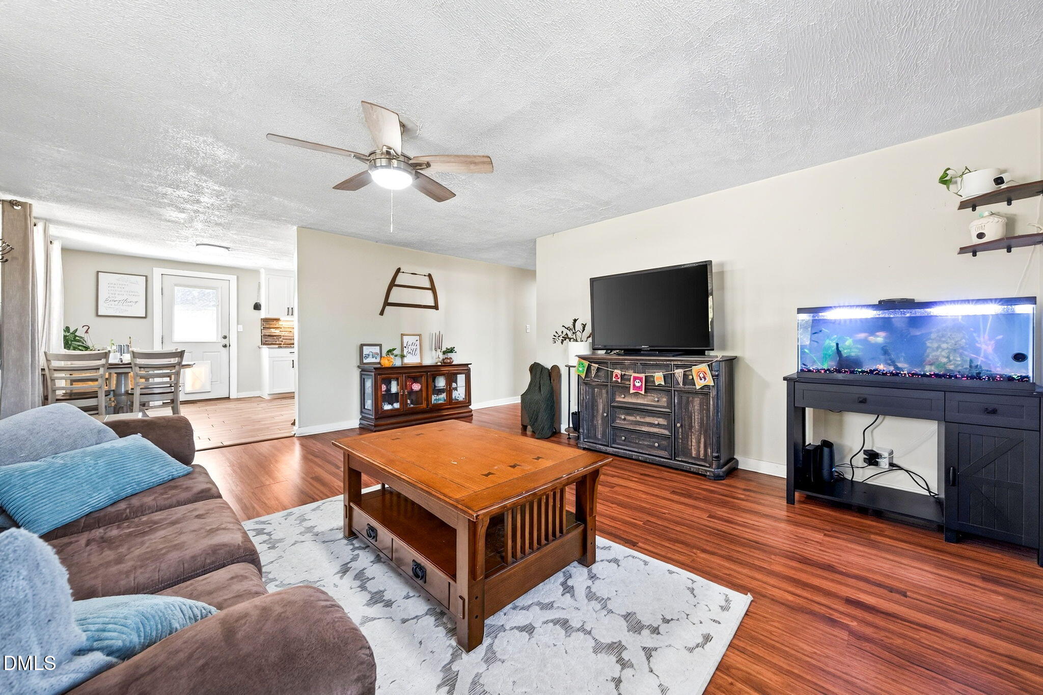 334 Perry Curtis Road Zebulon, NC 27597 - Photo 11 of 38 a living room with furniture and a flat screen tv