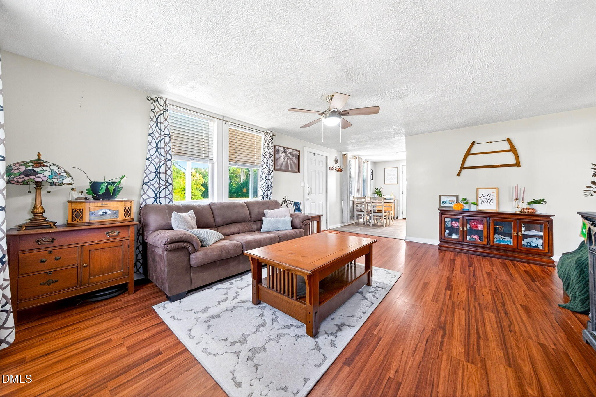 334 Perry Curtis Road Zebulon, NC 27597 - Photo 12 of 38 a living room with furniture and a wooden floor