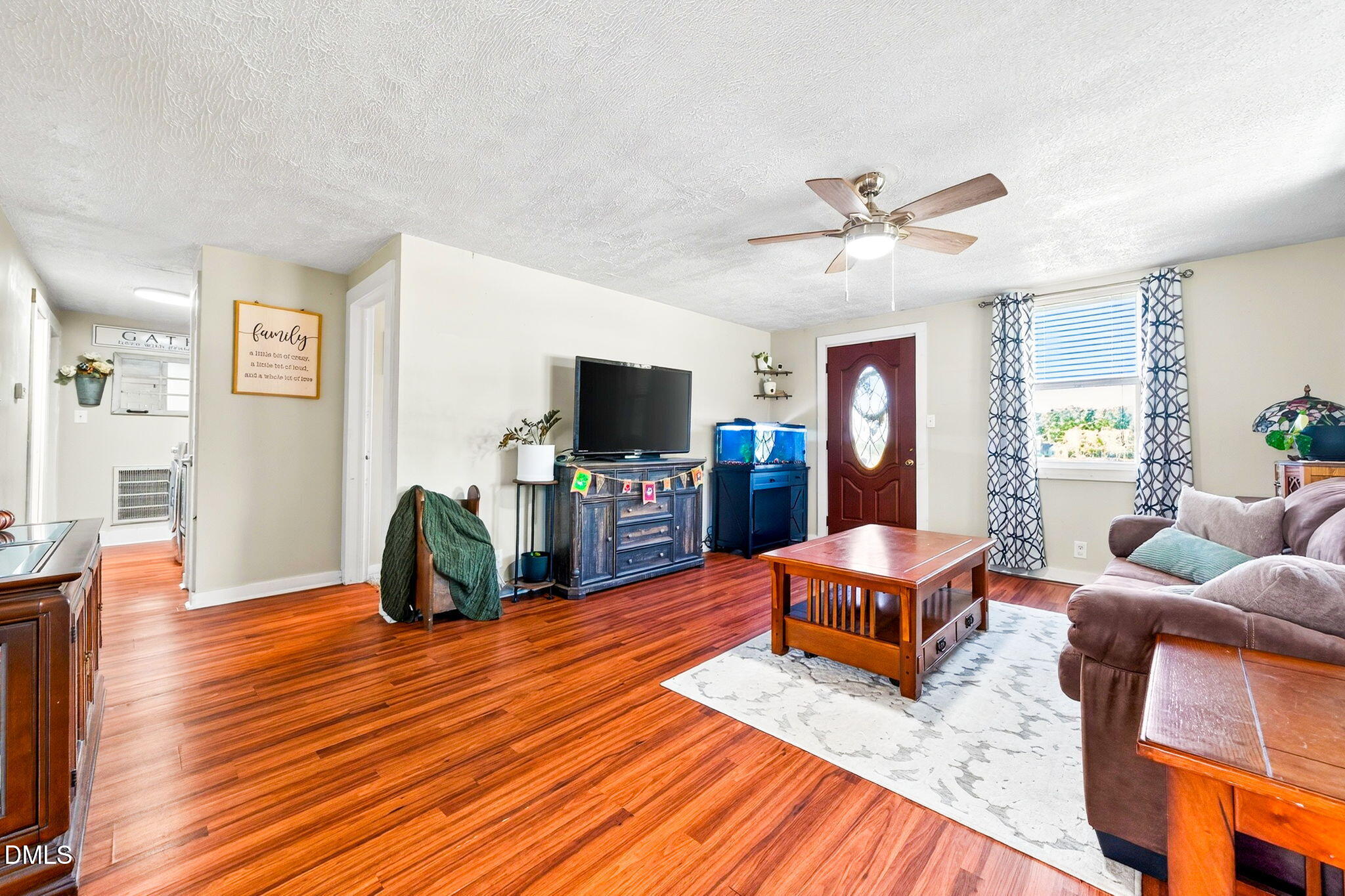 334 Perry Curtis Road Zebulon, NC 27597 - Photo 13 of 38 a living room with furniture and a flat screen tv