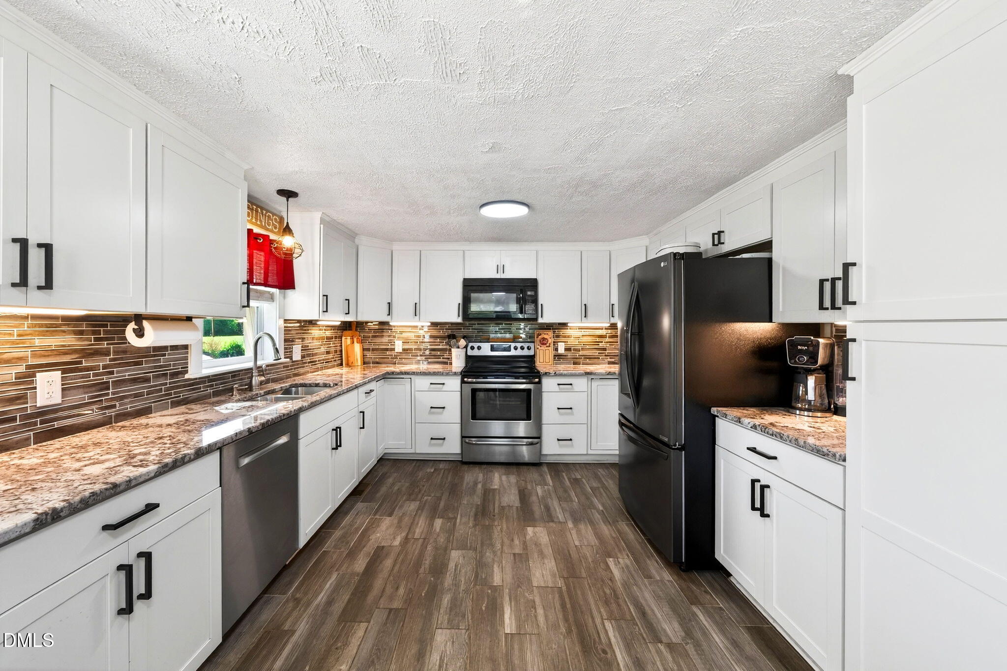 334 Perry Curtis Road Zebulon, NC 27597 - Photo 18 of 38 a kitchen with stainless steel appliances a refrigerator sink and stove