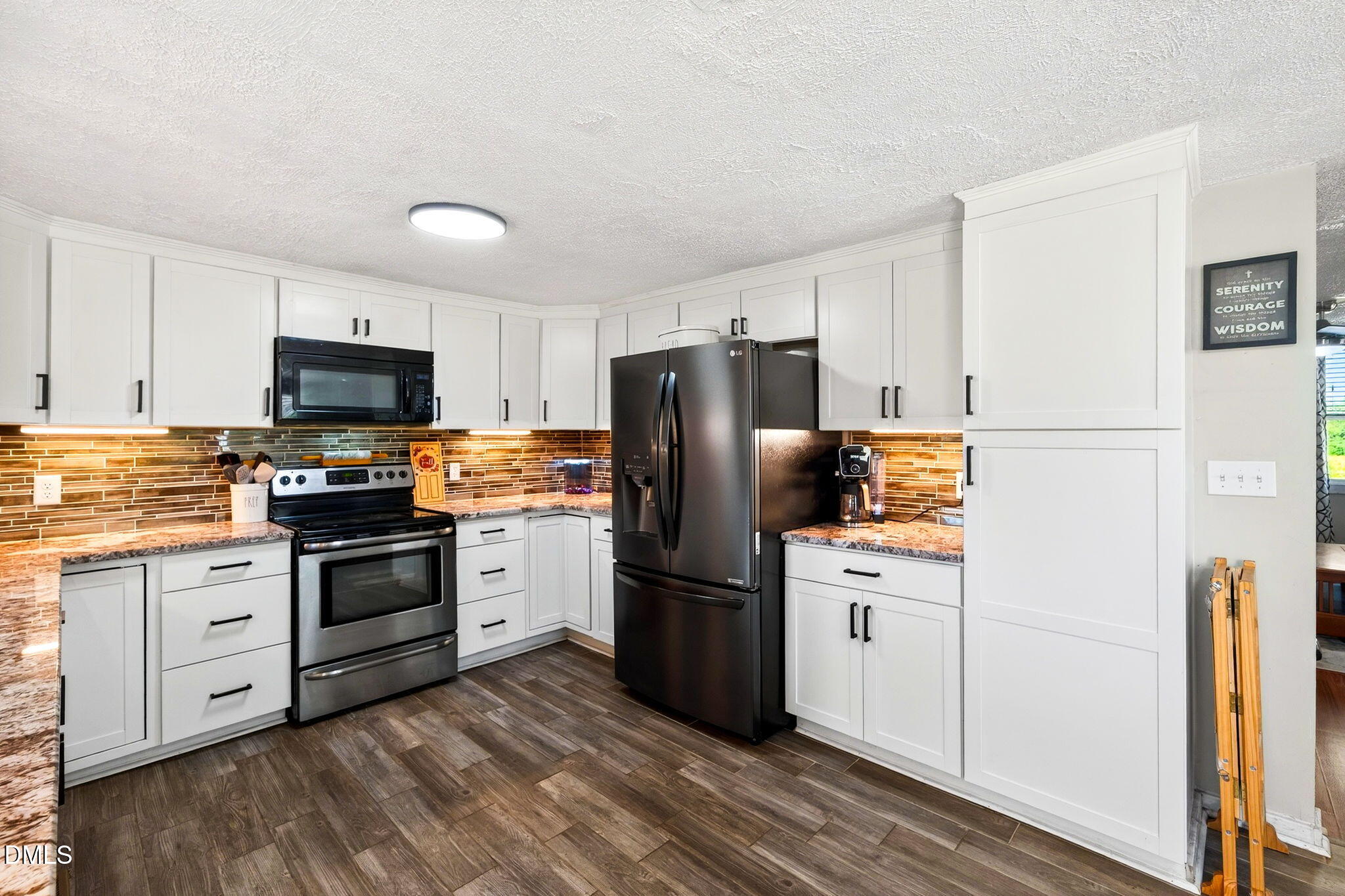 334 Perry Curtis Road Zebulon, NC 27597 - Photo 19 of 38 a kitchen with granite countertop a refrigerator stove top oven and sink