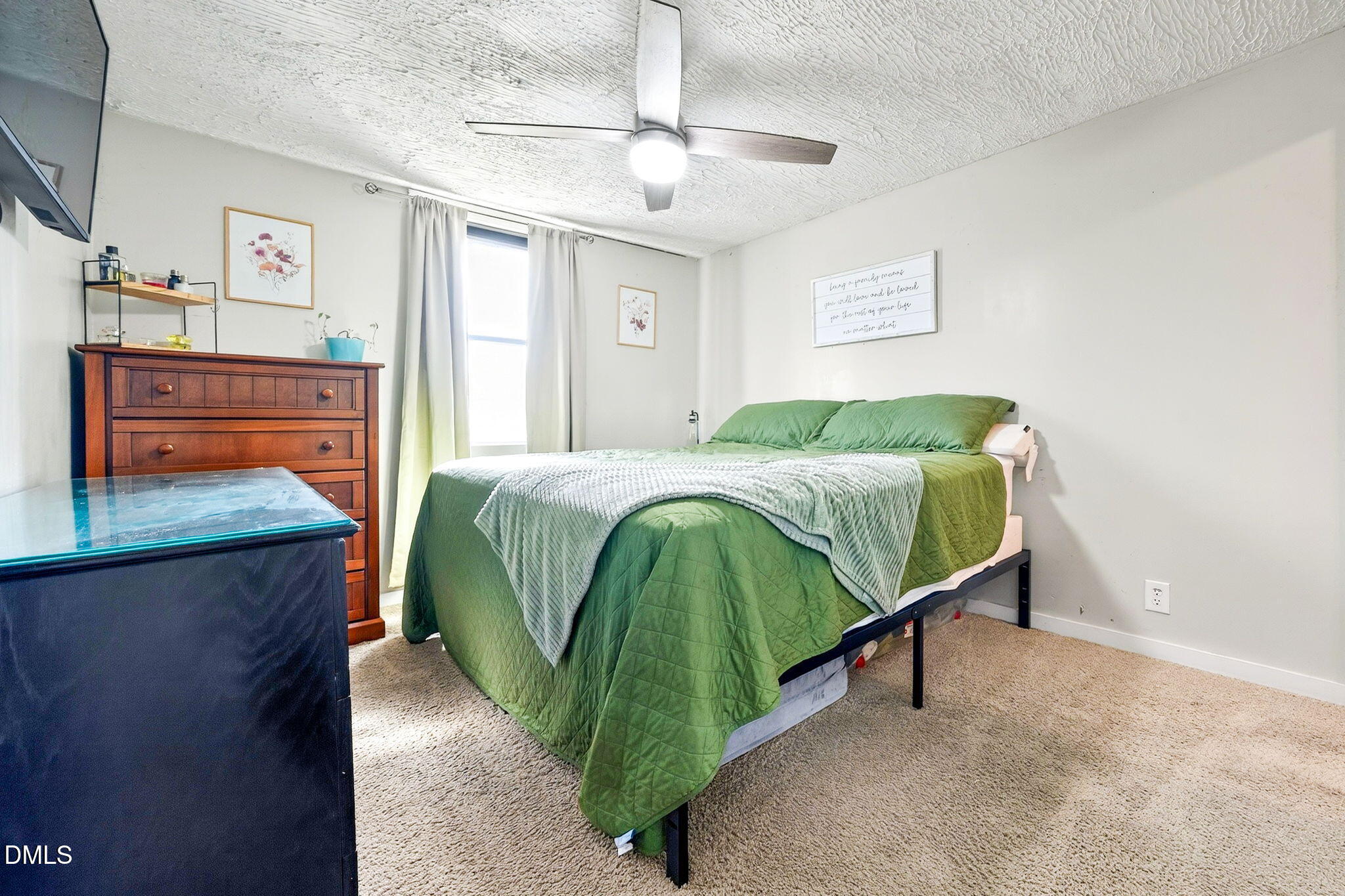 334 Perry Curtis Road Zebulon, NC 27597 - Photo 27 of 38 a bedroom with a bed and a flat tv screen on the dresser