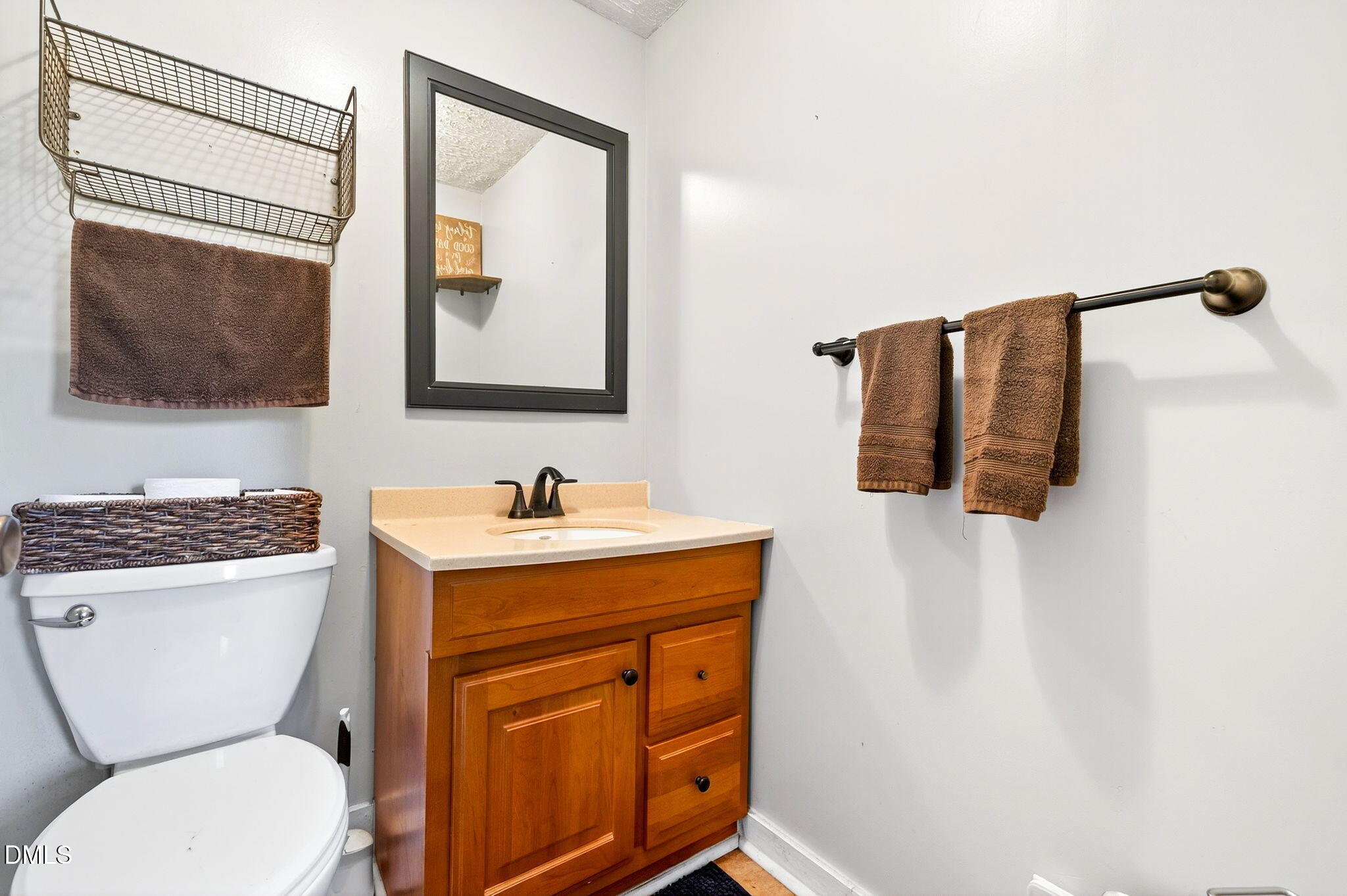 334 Perry Curtis Road Zebulon, NC 27597 - Photo 29 of 38 a bathroom with a toilet a sink and mirror