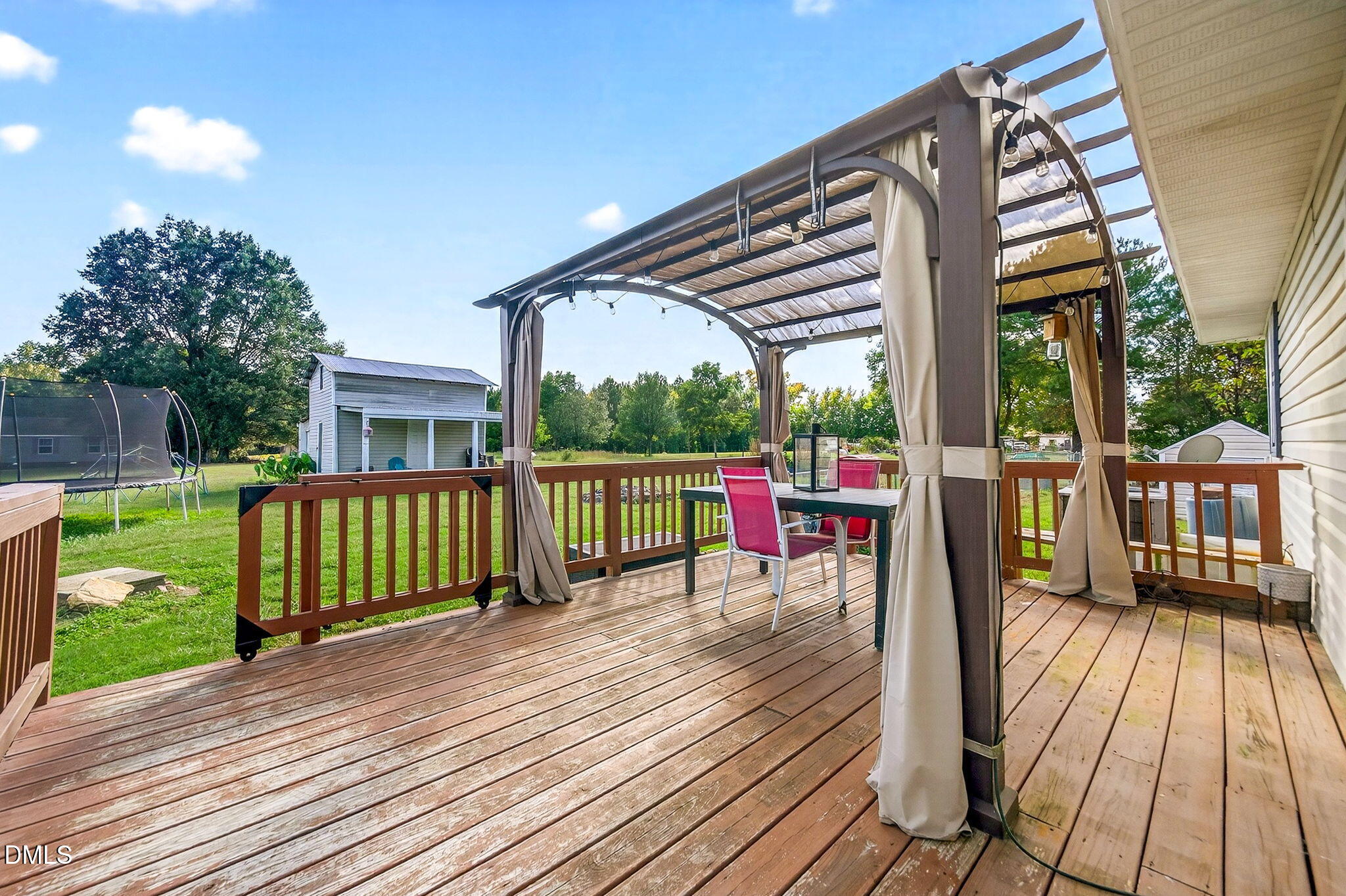 334 Perry Curtis Road Zebulon, NC 27597 - Photo 30 of 38 a view of a deck with wooden floor and iron fence