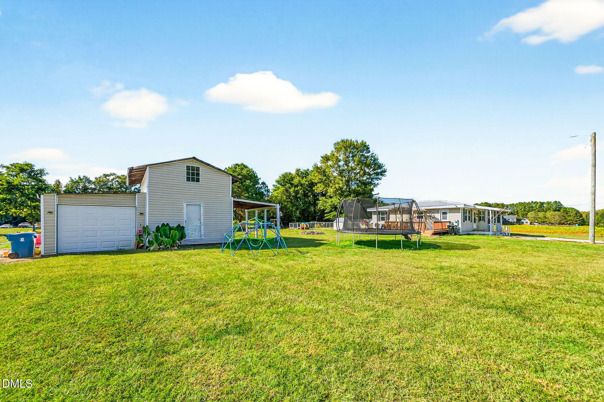 334 Perry Curtis Road Zebulon, NC 27597 - Photo 36 of 38 a view of a house with a big yard and a large tree