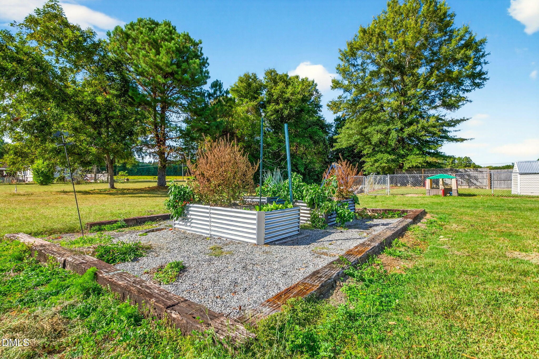 334 Perry Curtis Road Zebulon, NC 27597 - Photo 38 of 38 a view of a garden with large trees