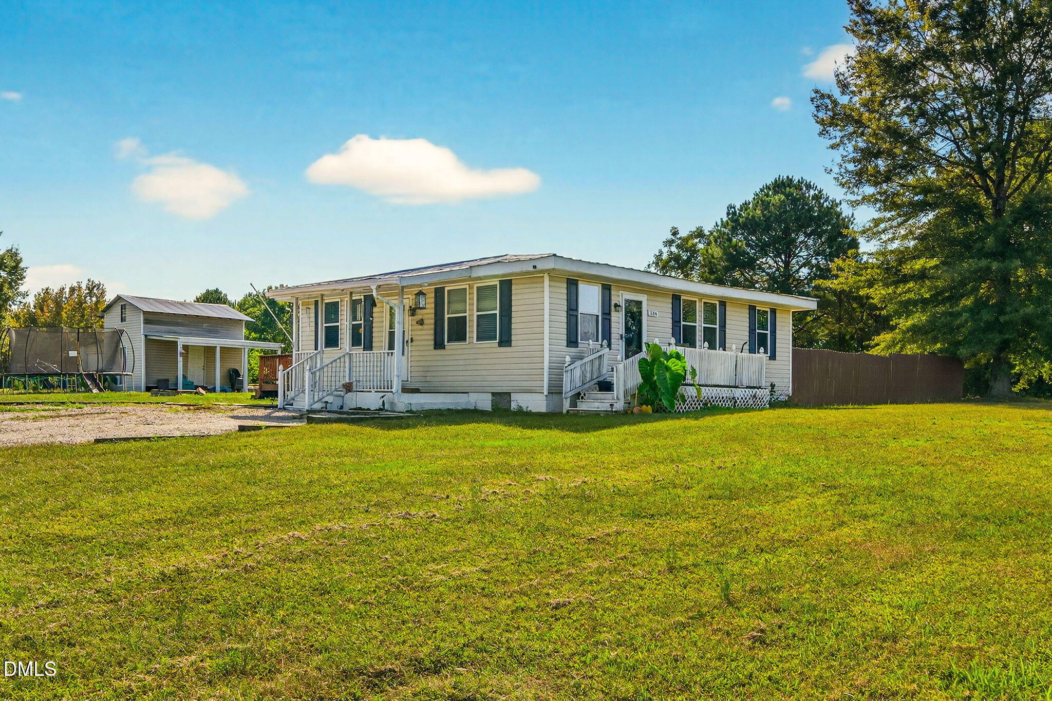 334 Perry Curtis Road Zebulon, NC 27597 - Photo 5 of 38 a front view of house with yard and trees in the background