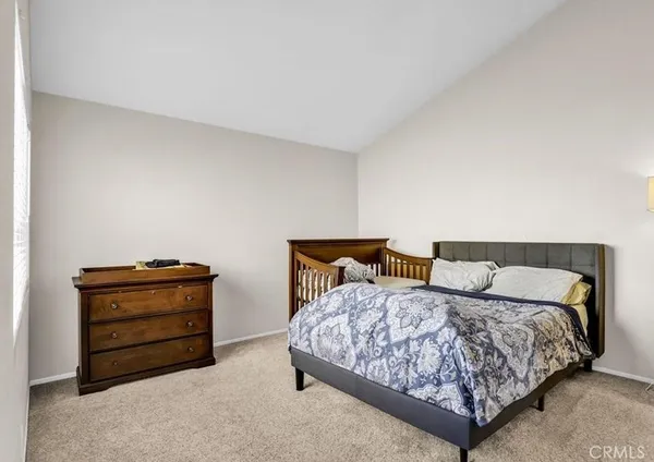 a bedroom with a bed and with furniture