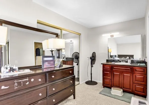 a kitchen with kitchen island granite countertop a stove a sink and a refrigerator