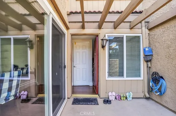 a view of a house with a patio and a yard