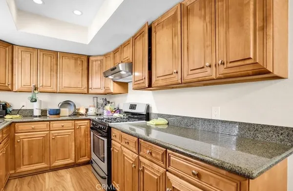 a kitchen with stainless steel appliances granite countertop a sink and cabinets