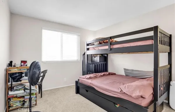 a bedroom with a bed and a desk