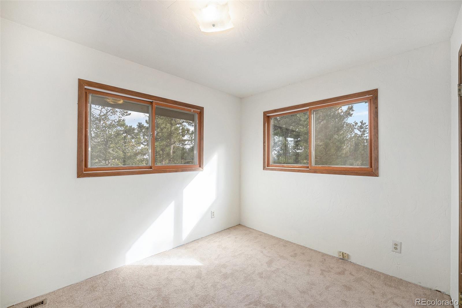 11540 Inspiration Road Golden, CO 80403 - Photo 13 of 33 a view of an empty room with window