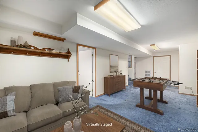 a living room with furniture a wooden floor and a window