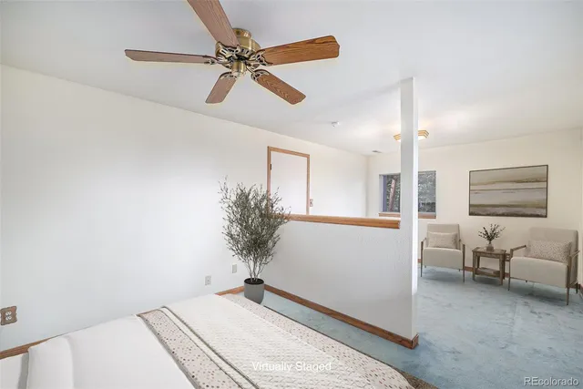 a bedroom with a bed and a potted plant