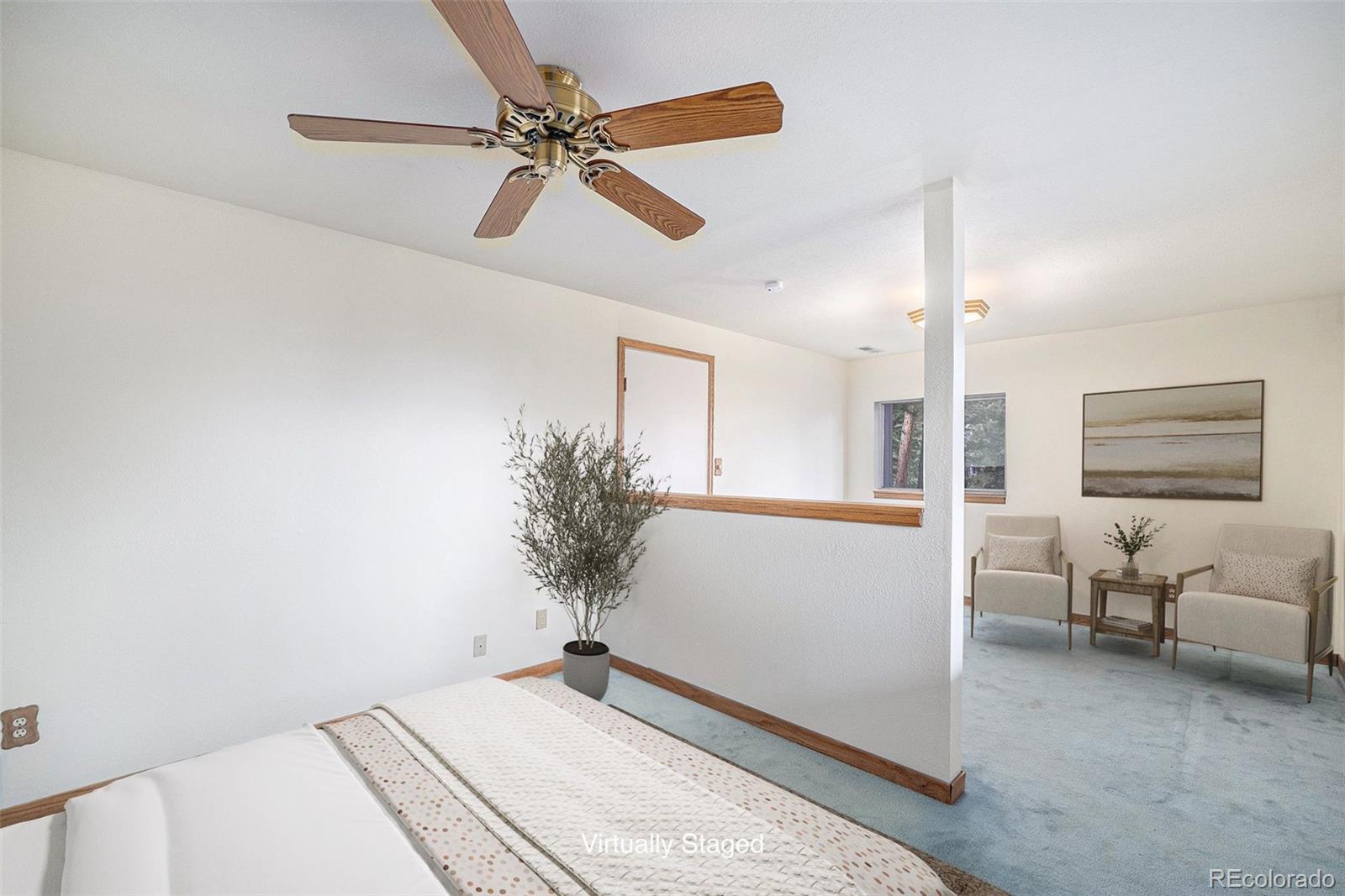 11540 Inspiration Road Golden, CO 80403 - Photo 16 of 33 a bedroom with a bed and a potted plant