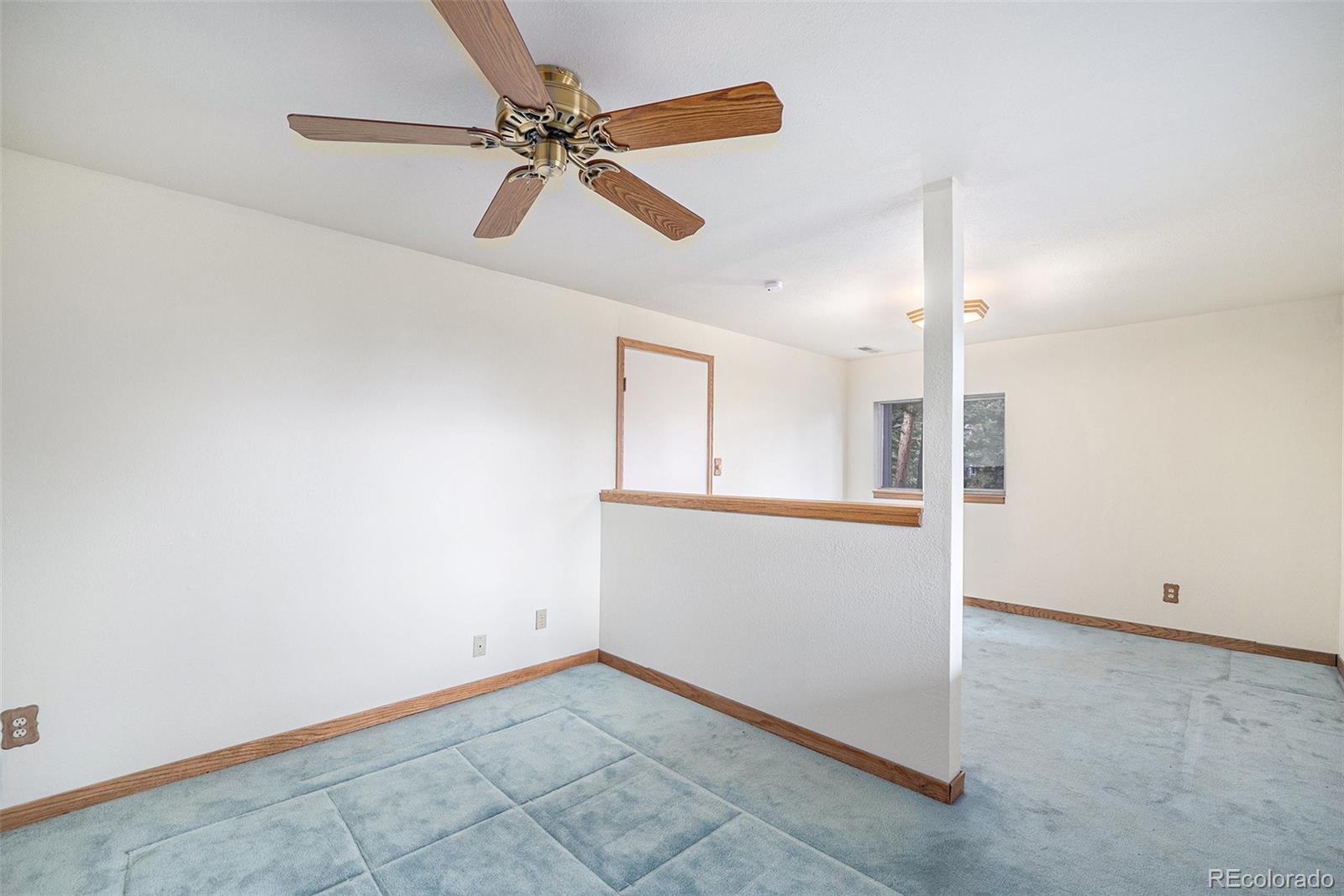 11540 Inspiration Road Golden, CO 80403 - Photo 17 of 33 an empty room with fan and windows