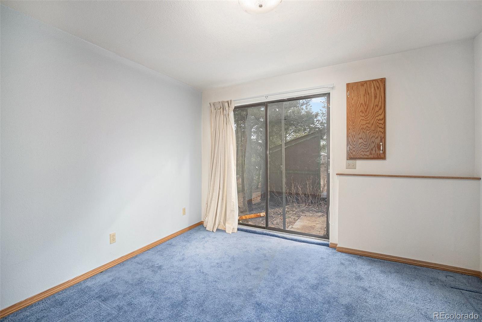 11540 Inspiration Road Golden, CO 80403 - Photo 18 of 33 an empty room with sliding door