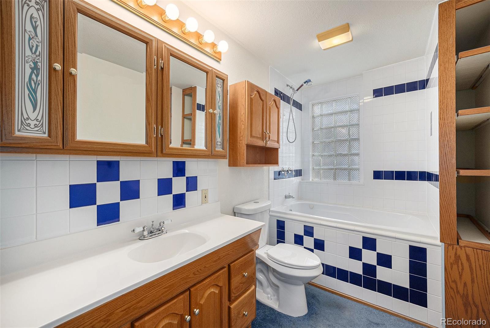 11540 Inspiration Road Golden, CO 80403 - Photo 19 of 33 a bathroom with a sink a toilet and shower