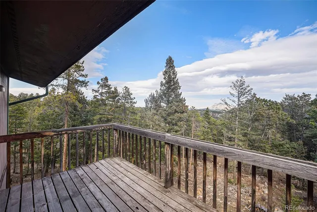 a balcony with wooden floor and fence