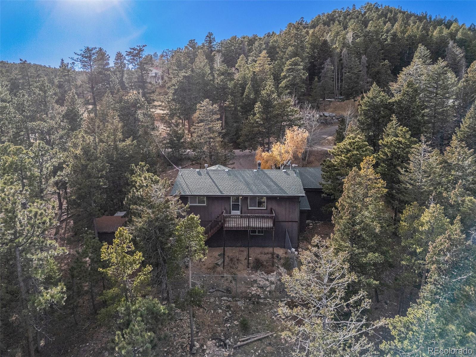 11540 Inspiration Road Golden, CO 80403 - Photo 25 of 33 a view of a house with a yard and tree s
