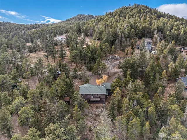 a backyard of a house with large trees