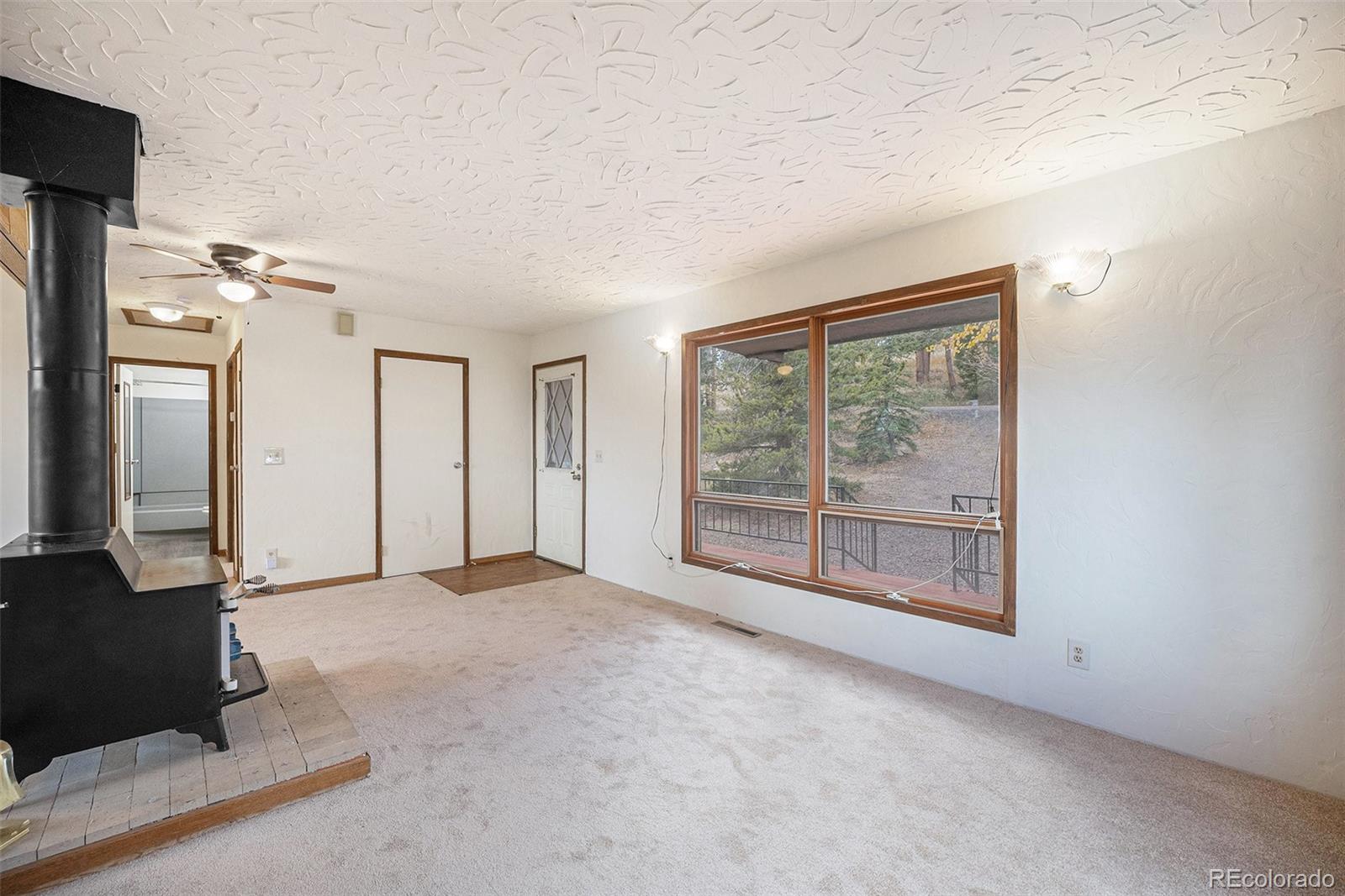 11540 Inspiration Road Golden, CO 80403 - Photo 6 of 33 an empty room with windows