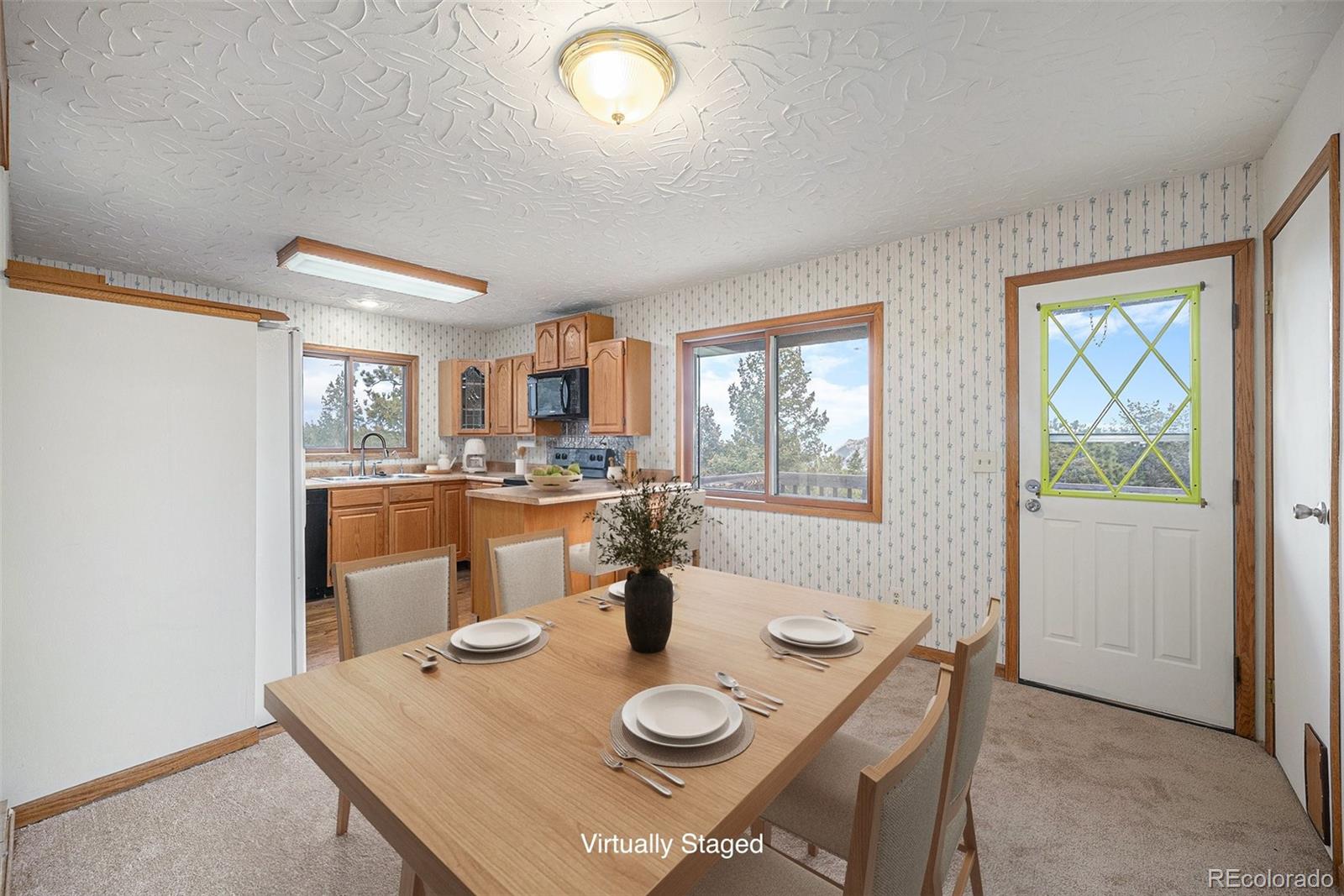 11540 Inspiration Road Golden, CO 80403 - Photo 7 of 33 a view of a dining room with furniture and wooden floor