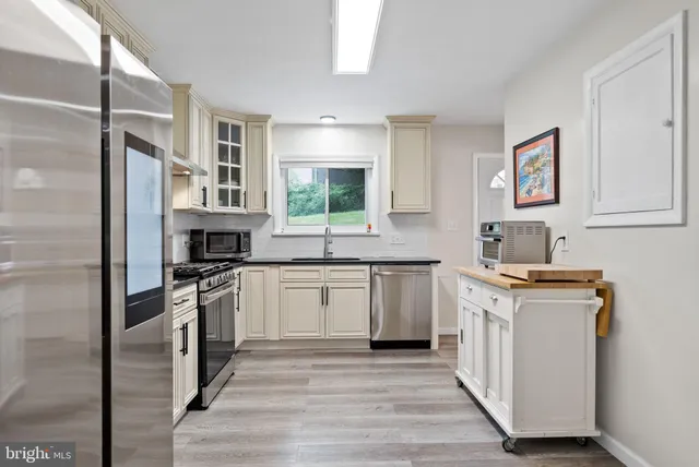 a bathroom with a sink mirror and shower