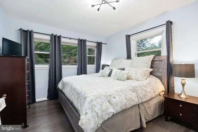 a kitchen with stainless steel appliances kitchen island a table chairs in it and wooden floors