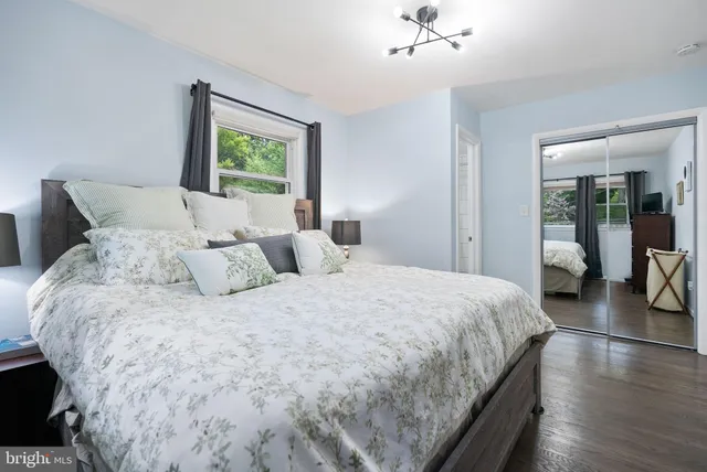 a kitchen with stainless steel appliances granite countertop a stove a sink and white cabinets with wooden floor