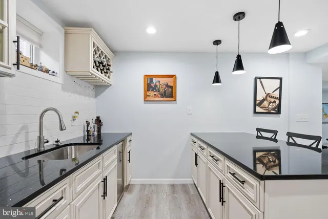 a front view of a house with cars parked