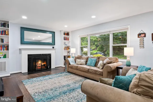 a living room with furniture a large window and a flat screen tv