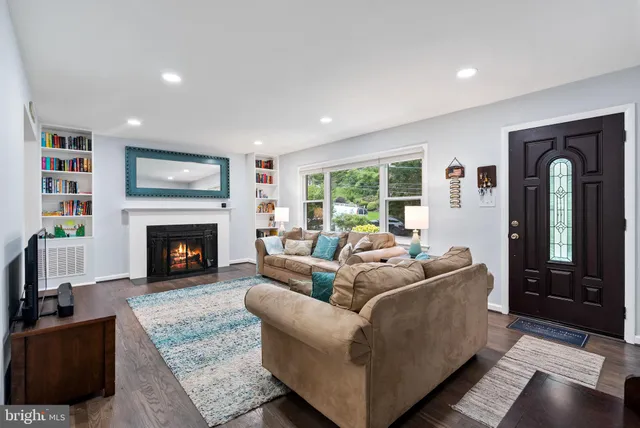 a living room with furniture wooden floor and a flat screen tv