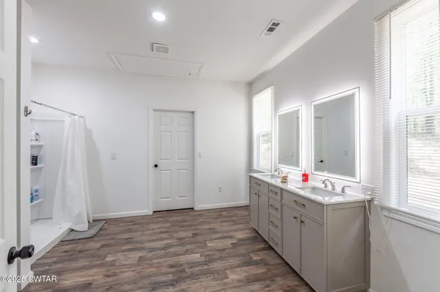 a bedroom with a bed and a ceiling fan