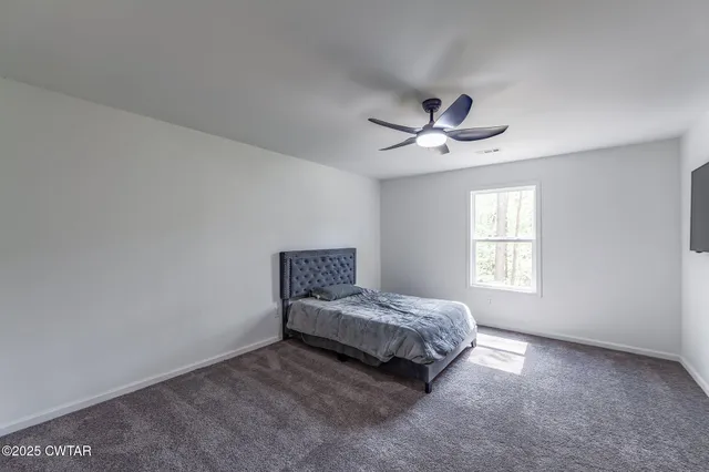 a view of a house with a yard covered in snow