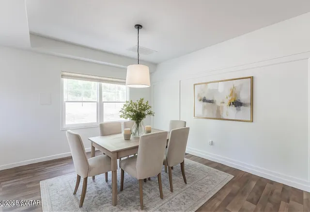 a bathroom with a granite countertop sink a toilet and a mirror