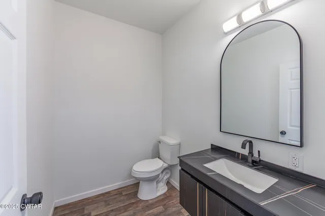 a kitchen that has a lot of cabinets a sink and appliances in it
